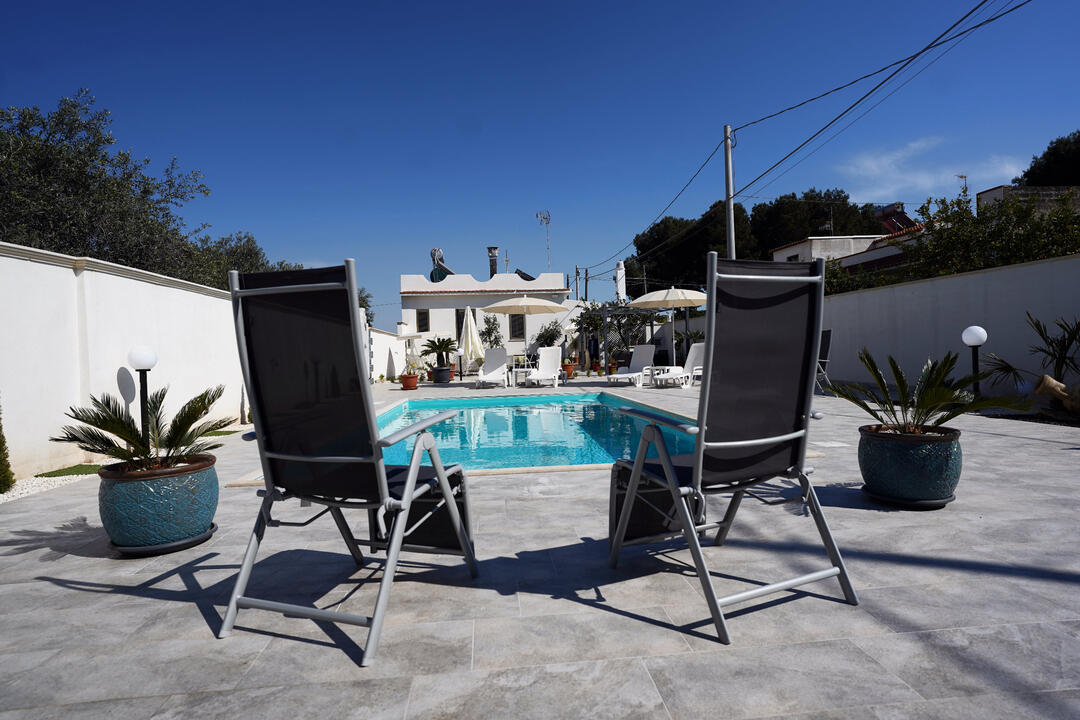 Outdoor pool with deck chairs Outdoor pool with deck chairs